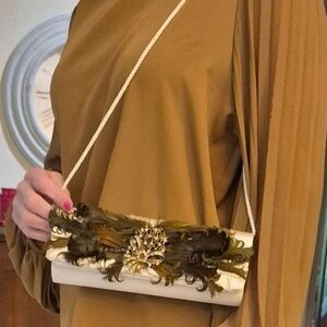 Chic Cream Clutch with Feather Embellishment